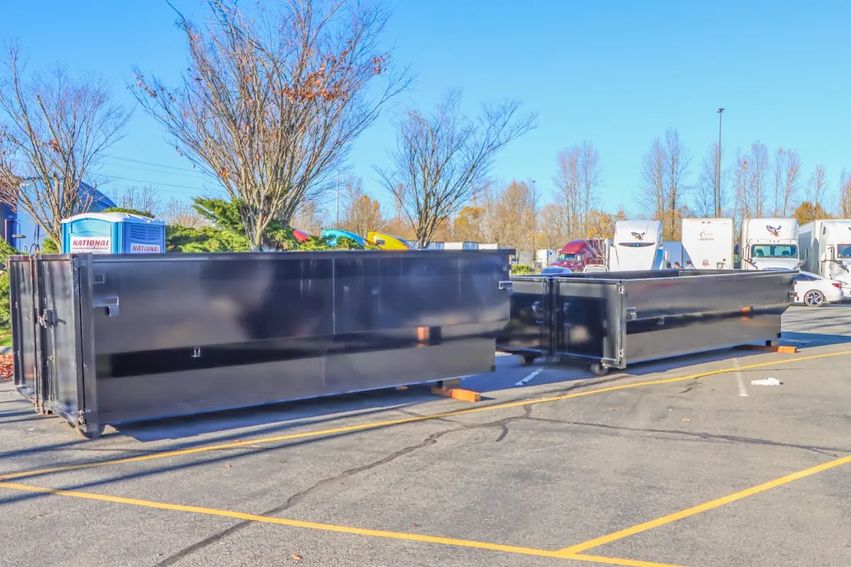 Professional dumpster rental service with roll-off container on residential driveway in Mabank